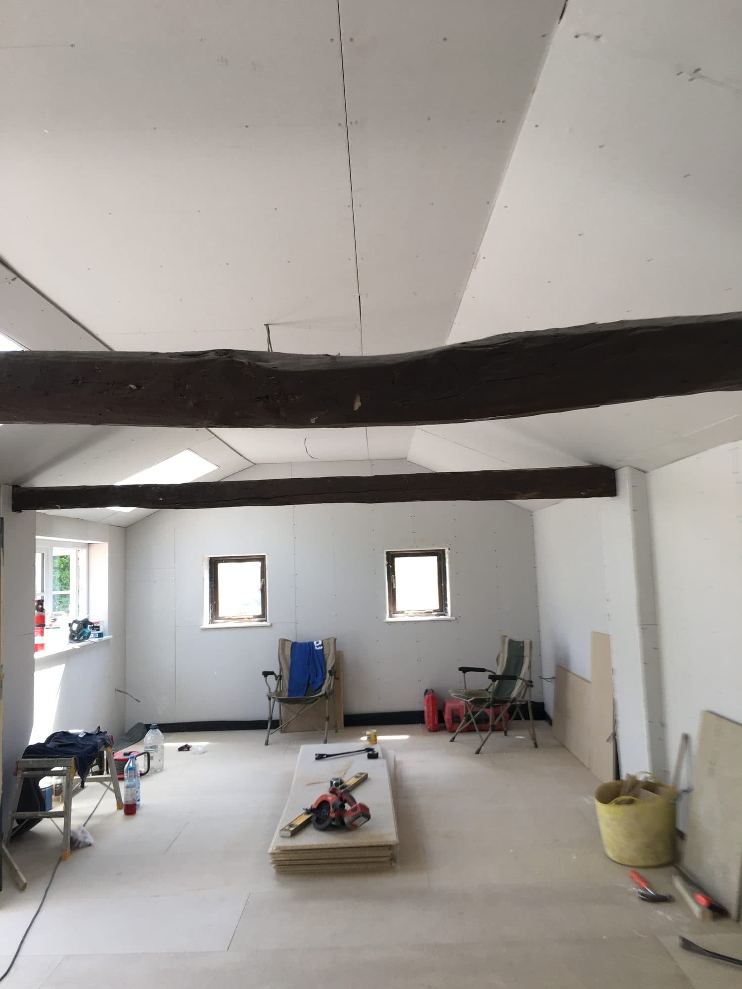 Inside, with exposed beams, ready for finishing