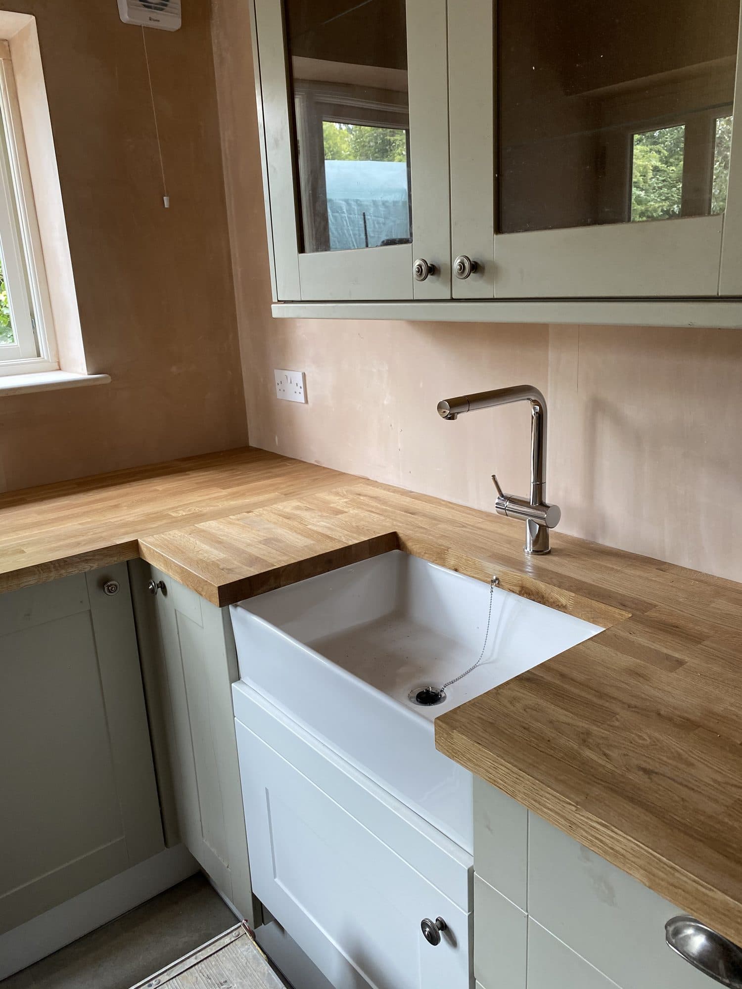 Belfast sink with oak worktops and glazed wall units